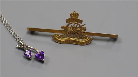 A 9ct gold Royal Artillery bar brooch and a silver and gem set necklace.